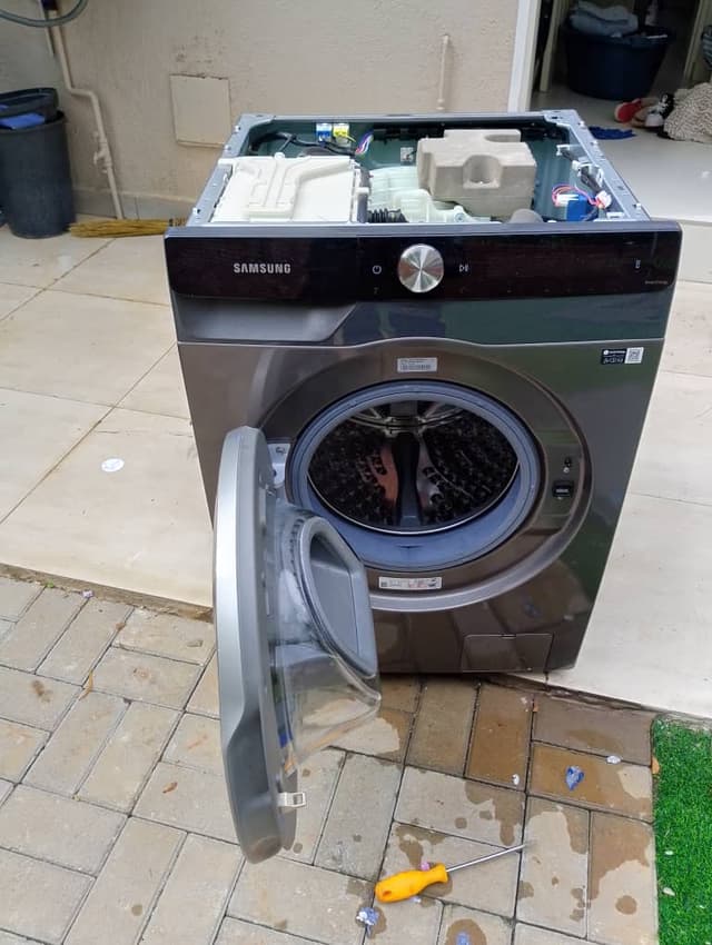 Tools and disassembled washer